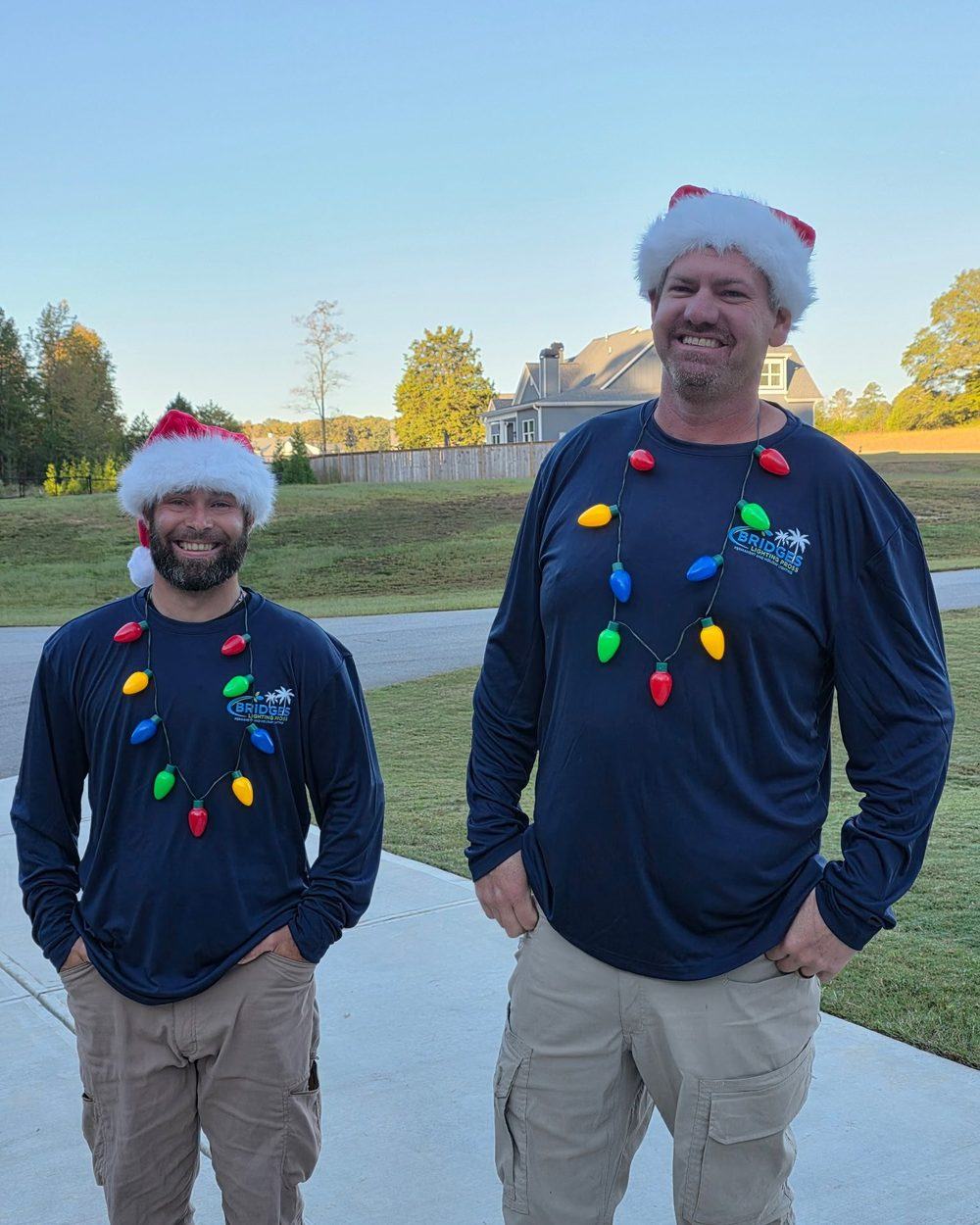 The Bridges Lighting Pros crew in branded shirts before a holiday installation